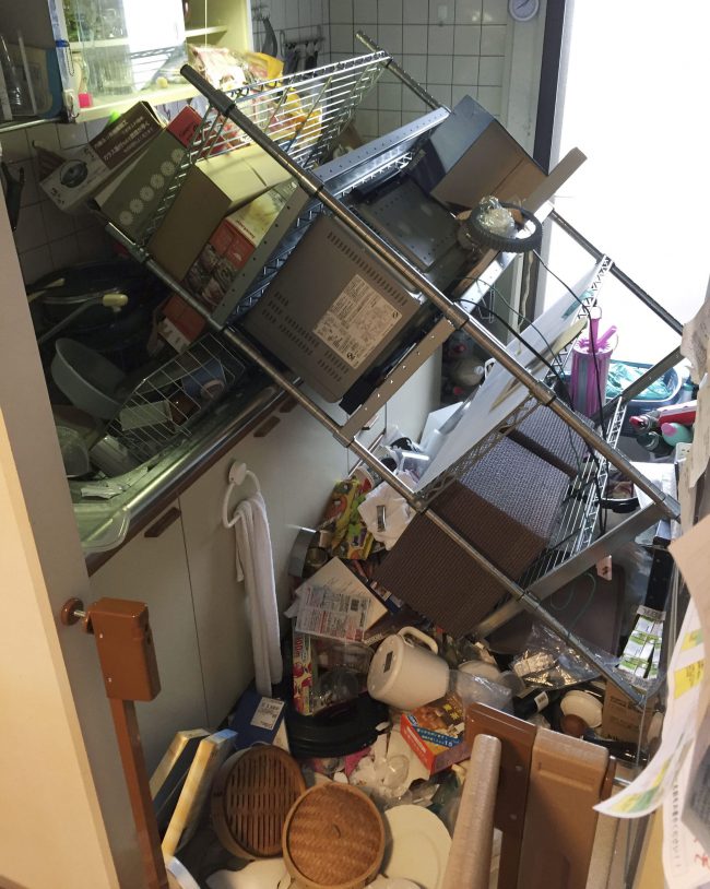 Scattered objects lie in the kitchen of a damaged house in Osaka, following an earthquake Monday, June 18, 2018.
