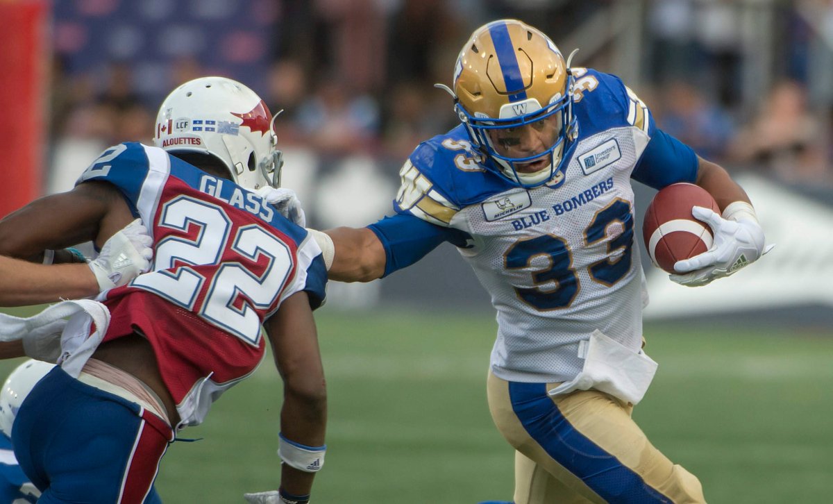 Winnipeg Blue Bombers Andrew Harris runs around Montreal Alouettes Tyquwan Glass during 1st half CFL action in Montreal Friday, June  22, 2018. 
