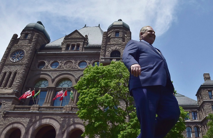 Ontario Premier Doug Ford walks out onto the front lawn of the Ontario Legislature at Queen's Park in Toronto on June 8, 2018.