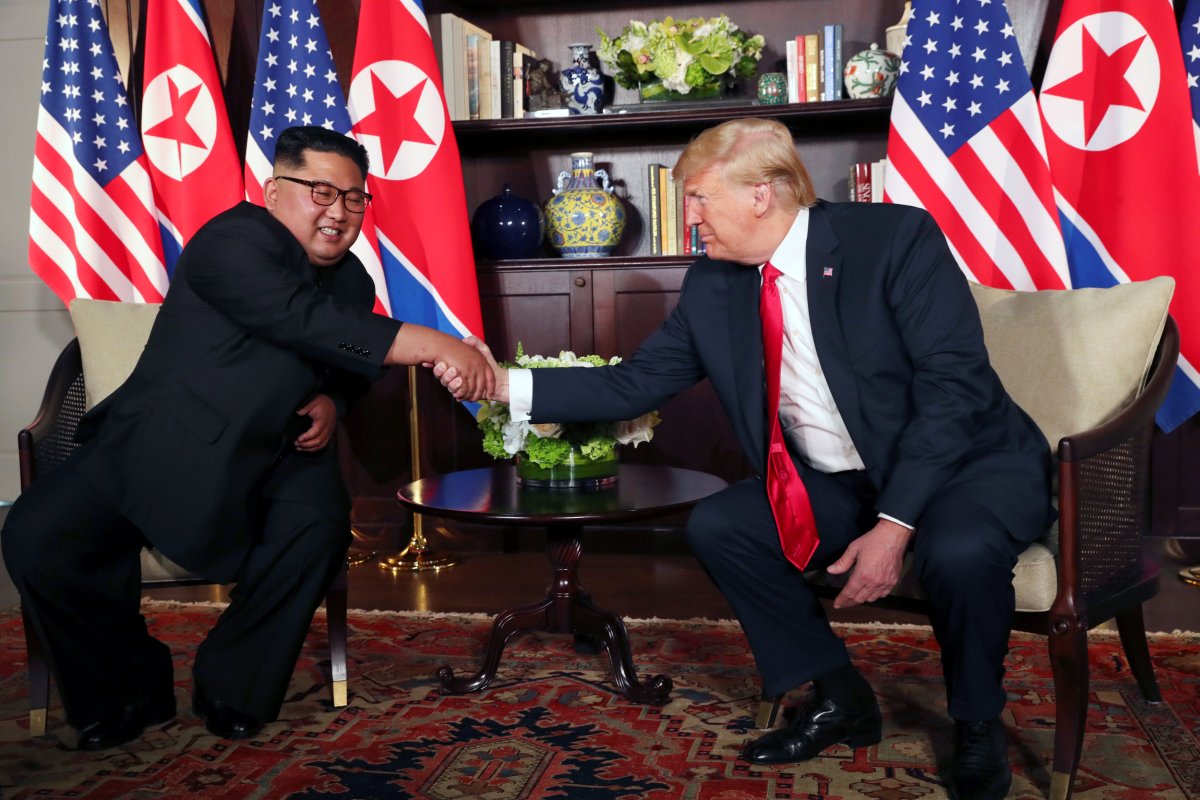 U.S. President Donald Trump shakes hands with North Korea's leader Kim Jong Un before their bilateral meeting at the Capella Hotel on Sentosa island in Singapore June 12, 2018. REUTERS/Jonathan Ernst.