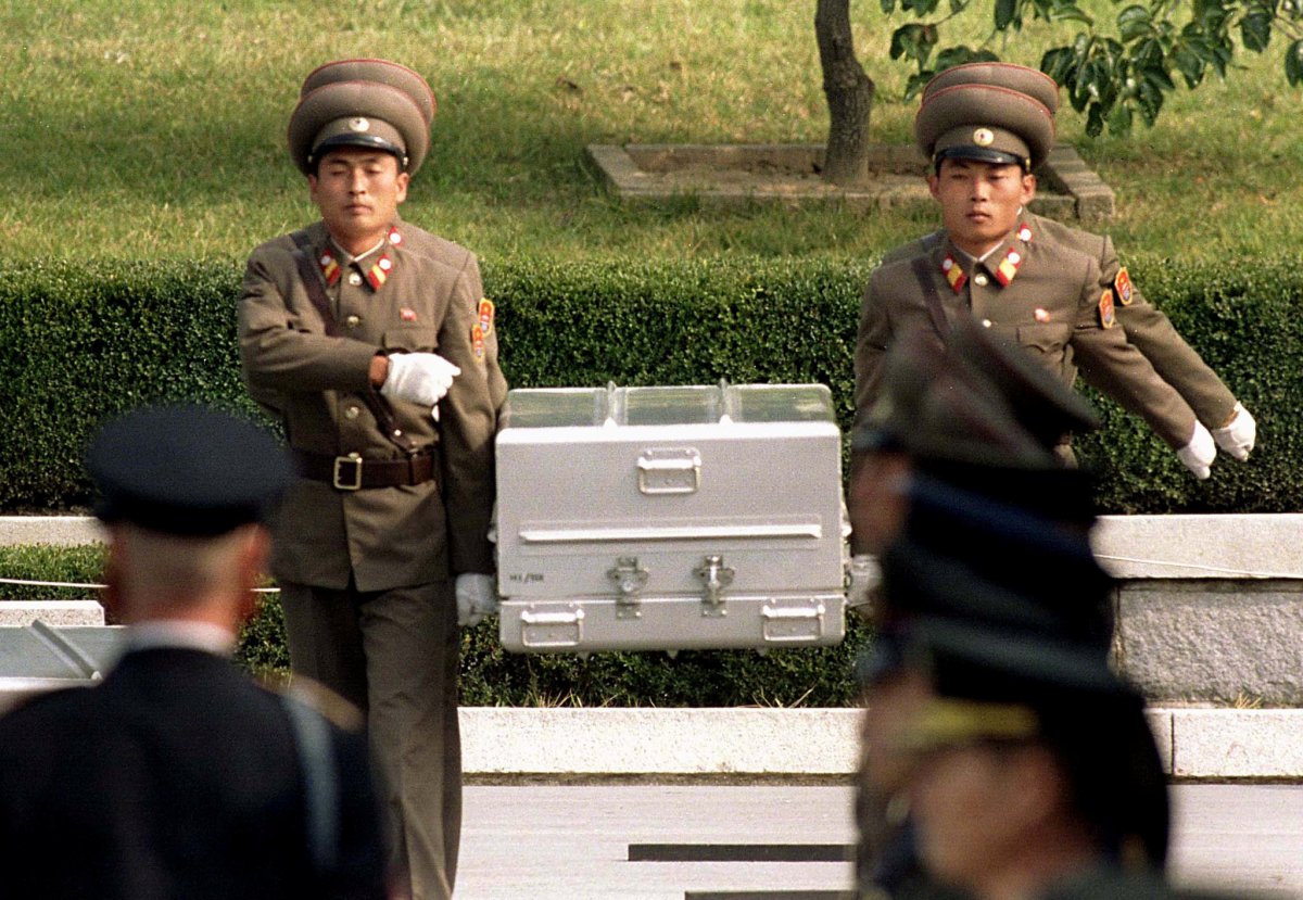North Korean soldiers carry a coffin believed to contain the remains of a U.S. soldier to the border with South Korea during repatriation ceremonies at the truce village of Panmunjom, South Korea, October 9, 1998. Reuters/Yun Suk Bong.
