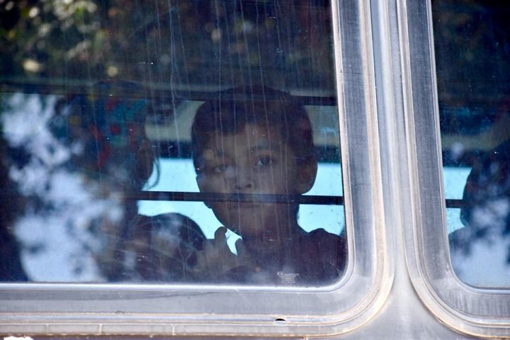 A child looks through the window of a bus carrying migrants near McAllen Detention Facility, McAllen, Texas, the U.S., June 23, 2018, in this photo obtained from social media. 