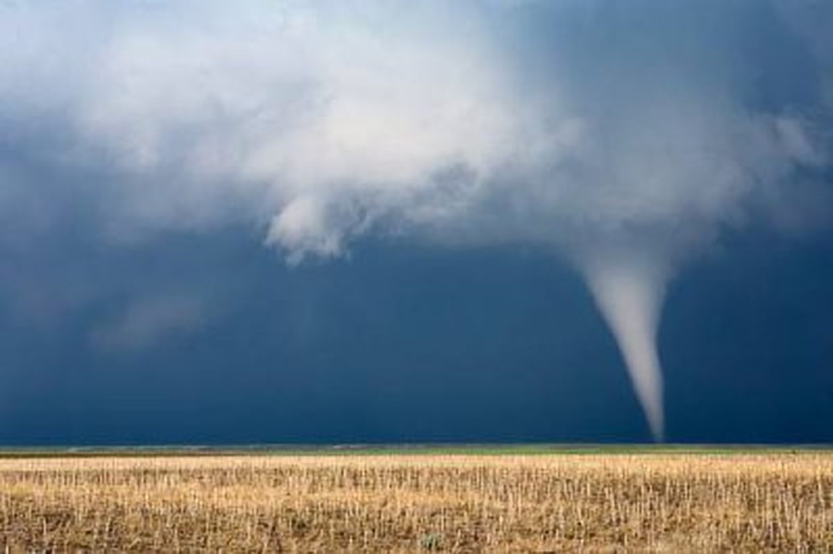 Scenic View Of Tornado Against Storm Clouds.