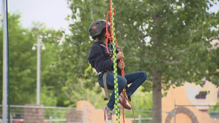 Ten-year-old Marissa Andrade learns how to climb at tree at Arbor Day in Winnipeg.