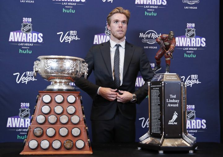 Edmonton Oilers' Connor McDavid poses with the Art Ross Trophy, left, and the Ted Lindsay Award after winning the honors at the NHL Awards, Wednesday, June 20, 2018, in Las Vegas. 