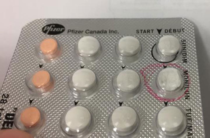 A package of Demulen 30 birth control pills with one pill (circled in red) that has a large piece missing from its top half.