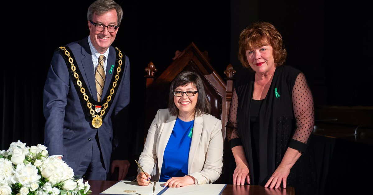Hélène Campbell (centre) receives her key to the city from Mayor Jim Watson and Barrhaven Coun. Jan Harder Thursday night.