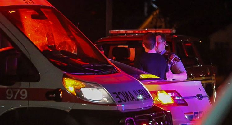 A New Brunswick RCMP officer takes a suspect into custody after a bear macing incident at a fair in Moncton on Friday, June 1, 2018.
