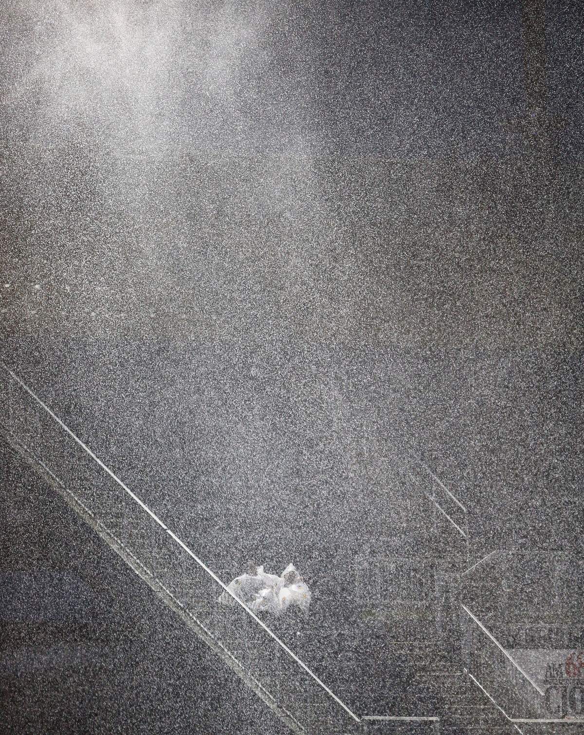 A couple sits in the rain as a lightning delay stopped play between the Edmonton Eskimos and the Winnipeg Blue Bombers during the first half of CFL action in Winnipeg Thursday, June 14, 2018.