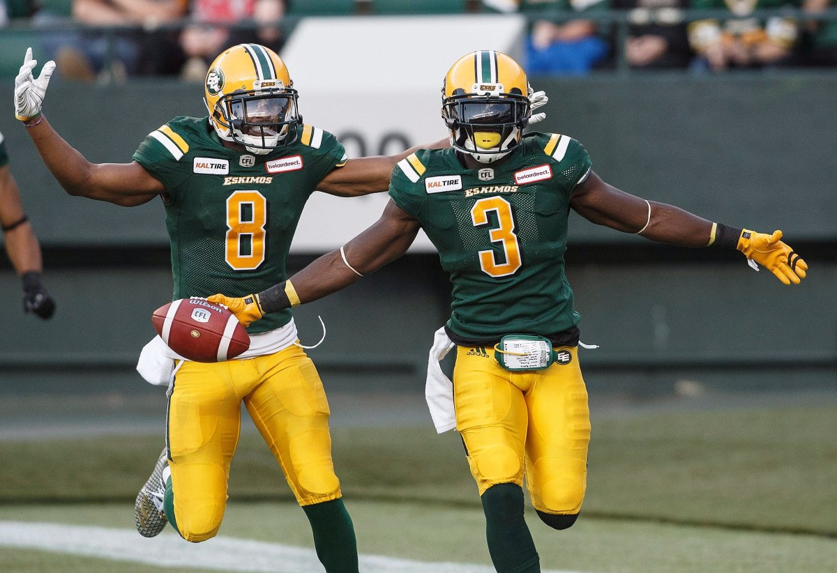 Edmonton Eskimos Kenny Stafford (8) and Natey Adjei (3) celebrate a touchdown against the B.C. Lions during first half CFL action in Edmonton, Alta., on Friday June 29, 2018.