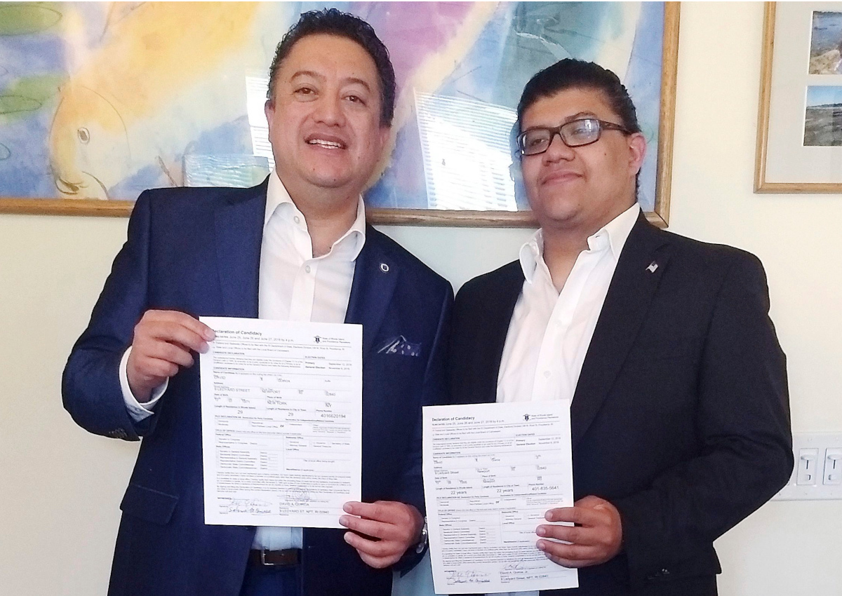 In this Tuesday, June 26, 2018 photo provided by David Quiroa, father David Quiroa, left, and son David Quiroa, Jr., right, hold their candidacy papers in Newport, R.I. 