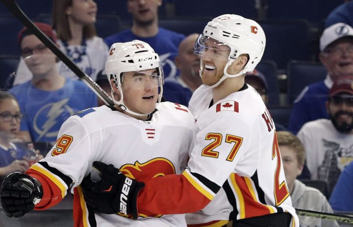Calgary Flames left wing Micheal Ferland (79) celebrates his goal against the Tampa Bay Lightning with defenseman Dougie Hamilton (27) during the first period of an NHL hockey game Thursday, Jan. 11, 2018, in Tampa, Fla.