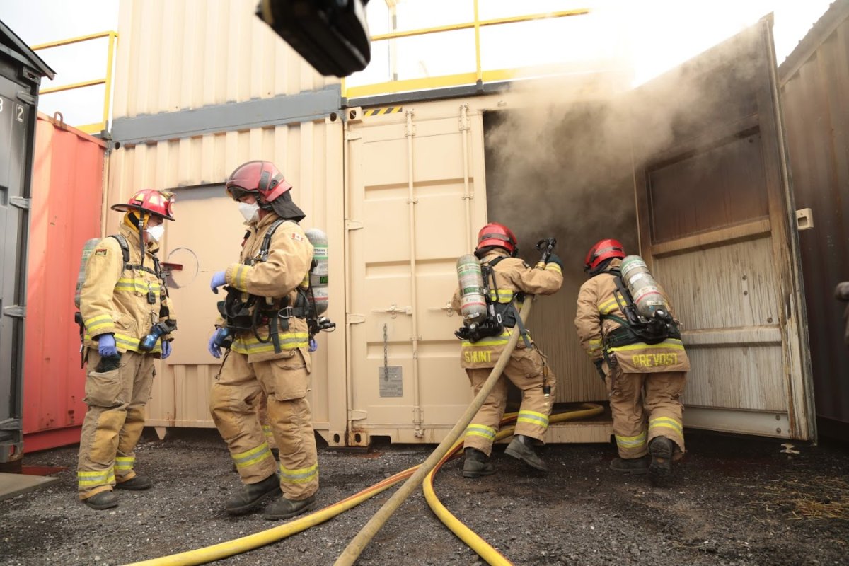 Firefighters participate in a training program developed and facilitated by Ottawa Fire Services at a site on Moodie Drive in the city's southwest end.
