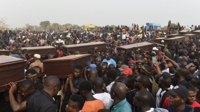 Pall bearers carry coffins during the funeral service for people killed during clashes between mostly Muslim cattle herders and Christian farmers in the Benue state capital Makurdi, Nigeria, Jan. 11, 2018. 

