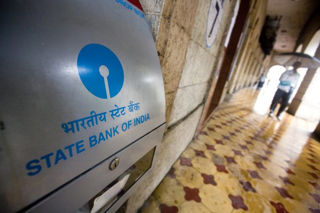 People walk past the State Bank of India main branch office in Mumbai, India, July 28, 2008. 


