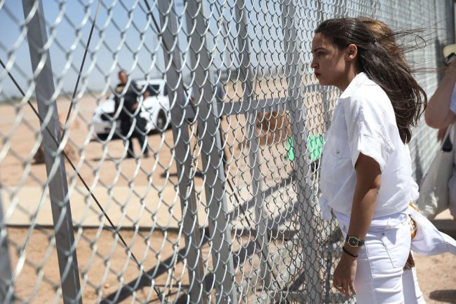 Alexandria Ocasio-Cortez stands at the Tornillo-Guadalupe port of entry gate on June 24, 2018, in Tornillo, Texas, where she was part of a group protesting the U.S. administration’s zero-tolerance policy to illegal immigrants.