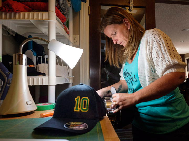 Susan Bissonnette, owner of The Stitching Bees, who volunteered to make Ryan Straschnitzki hats as part of a fund raising campaign for the injured Humboldt Broncos player and the extra care he will need once released from hospital, works on hats at her home in Airdrie, Alta., Thursday, June 7, 2018.