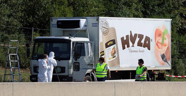 Police walk near a truck in which 71 migrants were found dead, near Parndorf, south of Vienna, Austria, Aug 27, 2015.