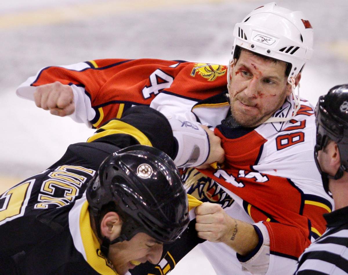 Panthers defenseman Nick Boynton, right, throws a punch during a fight with Boston Bruins left wing Milan Lucic in Boston, Friday Nov. 21, 2008.
