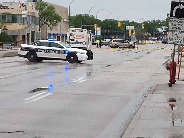 Winnipeg police taped off part of Portage Avenue Saturday to investigate a crash between a van and a motorcycle. 
