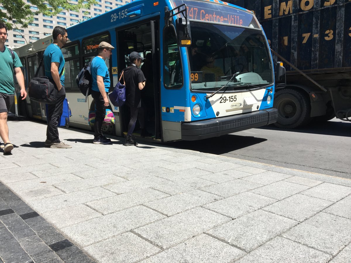 In this file phto, people can be seen boarding an STM bus in downtown Montreal. Front-door boarding will resume gradually as buses are retrofitted with protective screens for drivers. Friday, June 16, 2020.