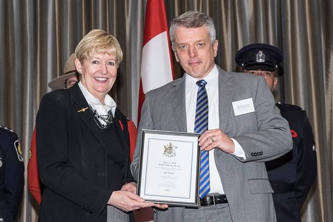 Attorney General and Minister of Justice Suzanne Anton, left, congratulates Vancouver Police Department Det. Const. Jim Fisher at the 16th annual Ministry of Justice Community Safety and Crime Prevention Awards in Burnaby on October 31, 2014 in this handout photo.

