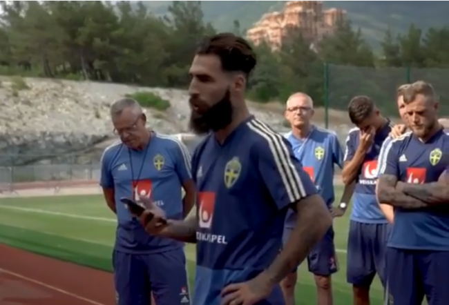 Swedish national team soccer player Jimmy Durmaz reads a statement while teammates and coach Janne Andersson are seen in the background, June 24, 2018 in Gelendzhik, Russia. 