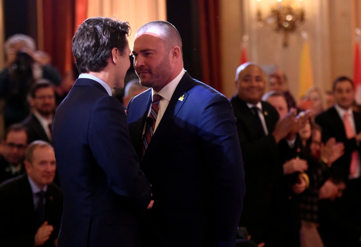 Canadian Prime Minister Justin Trudeau shakes hands with Ottawa City councillor and Afghanistan veteran Jody Mitic, right, during a ceremony to promote the 2017 Invictus Games, which the city will be hosting, on Monday, May 2, 2016.