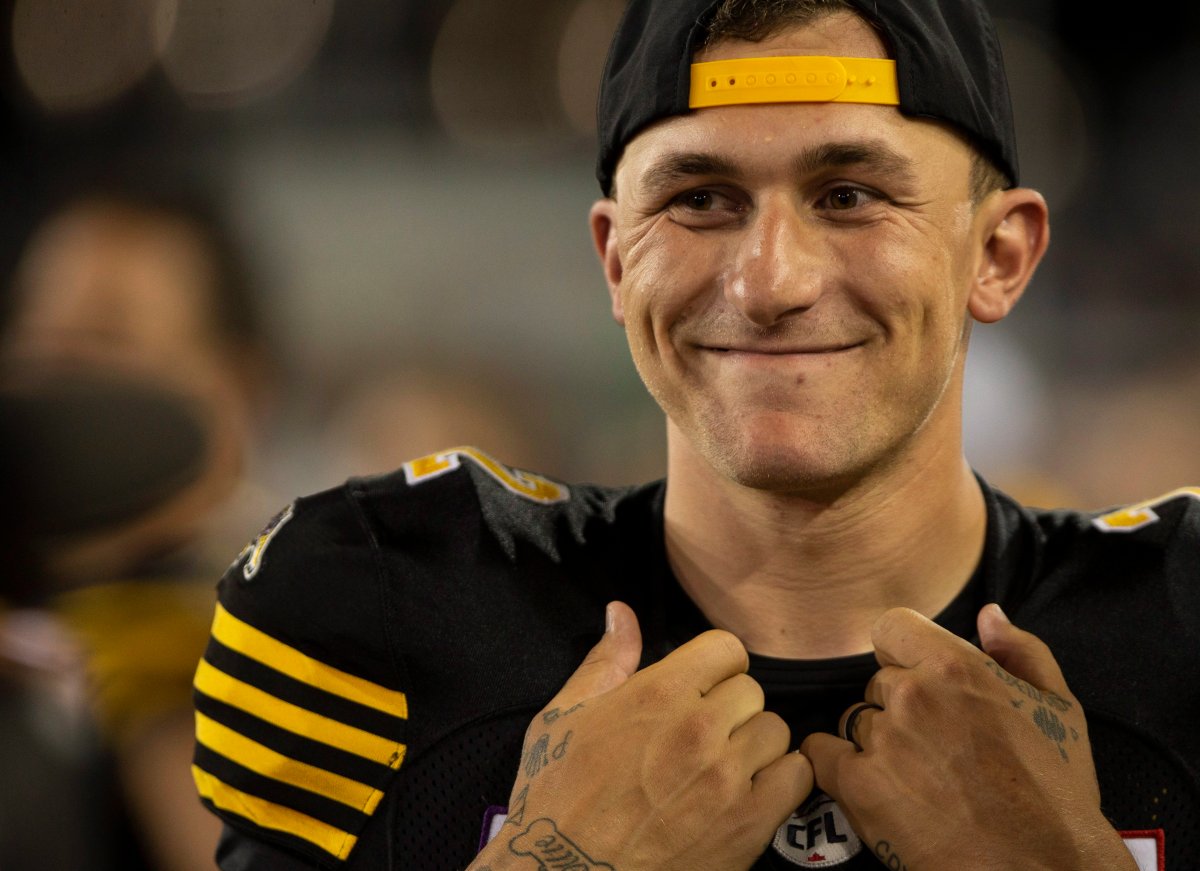 Hamilton Tiger-Cats quarterback Johnny Manziel (2) smiles on the bench during the second half of CFL Football exhibition game action against the Toronto Argonauts in Hamilton, Ont. on Friday, June 1, 2018. THE CANADIAN PRESS/Peter Power.