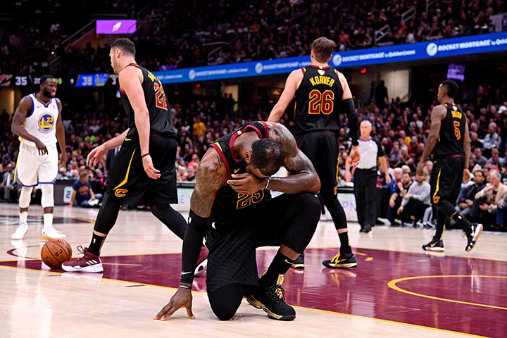 Cleveland Cavaliers forward LeBron James reacts after an injury during the second quarter against the Golden State Warriors in game four of the 2018 NBA Finals at Quicken Loans Arena.