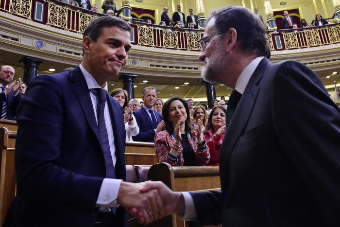 Spain's Prime Minister Mariano Rajoy, right, shakes hands with socialist leader Pedro Sanchez after a motion of no confidence vote at the Spanish parliament in Madrid, Friday, June 1, 2018. 