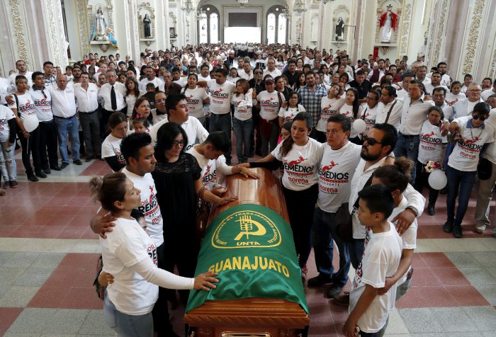 Friends and relatives pay their last respects to Jose Remedios Aguirre, a mayoral candidate who was shot in broad daylight two days prior, during his funeral Mass in Apaseo El Alto, Mexico, Sunday, May 13, 2018. 