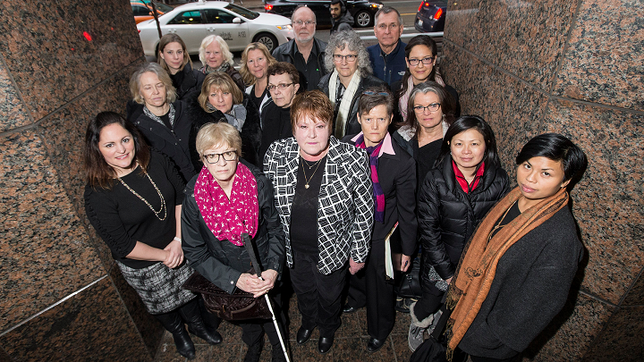 TORONTO, ON – JANUARY 23 – Lee-Ann McFarlane, President of OPP Civilian Association of Managers and Specialists (Black and white jacket) is surrounded by fellow employees who allege systemic discrimination by the OPP, saying they are paid 36-42 per cent less than their male, uniform counterparts.