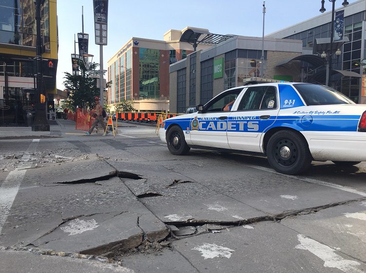A section of Portage Avenue at Donald Street closed Wednesday after the pavement buckled.