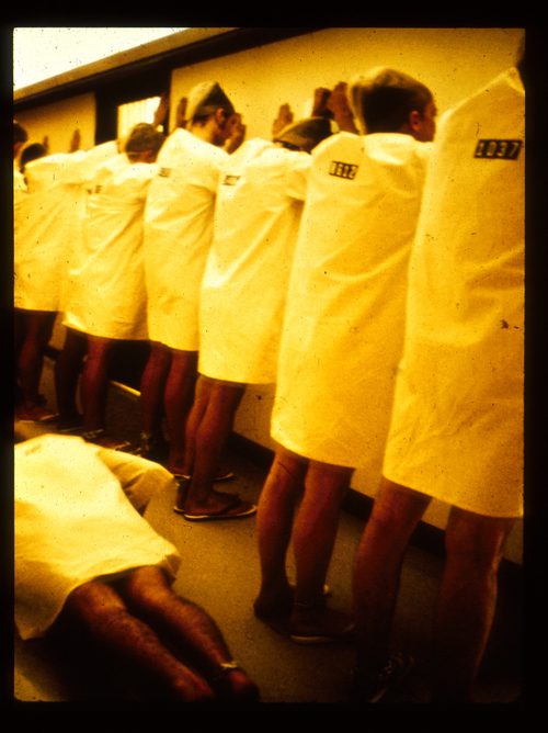 Prisoners line up while one of them does push-ups during the Stanford Prison Experiment in 1971.