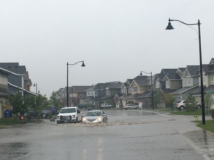 A rain-flooded street in Auburn Bay Saturday, June 23, 2018.