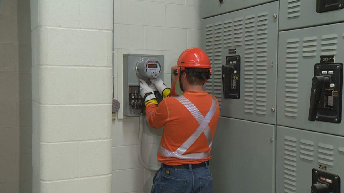 A SaskPower technician installs a new smart meter at one of their Regina facilities. 