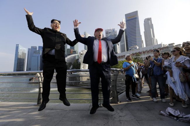 Kim Jong Un impersonator Howard X and Donald Trump impersonator Dennis Alan pose for photographs during their visit to the Merlion Park, a popular tourist destination in Singapore, June 8, 2018.