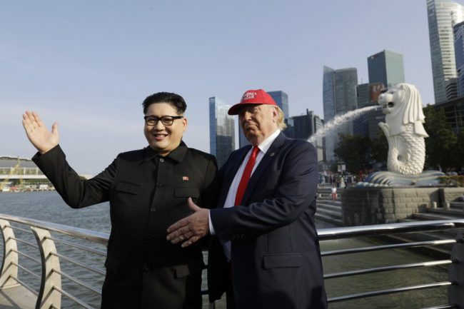 Kim Jong Un impersonator Howard X and Donald Trump impersonator Dennis Alan pose for photographs during their visit to the Merlion Park, a popular tourist destination in Singapore, June 8, 2018.