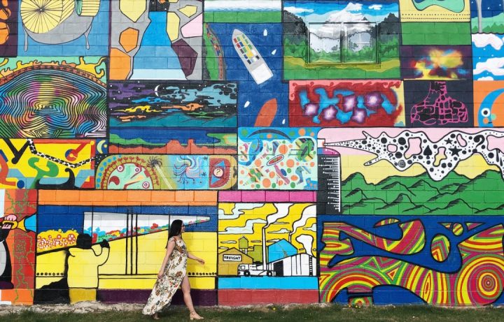 Linda Hoang in front of an Edmonton mural.