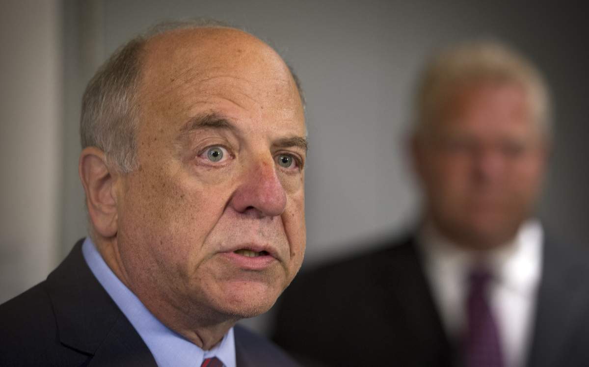 Dr. Rueben Devlin, left, and Doug Ford appear in a 2014 file photo.