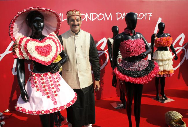 India’s first openly gay royal and AIDS activist, Prince Manvendra Singh Gohil poses with dresses made of condoms on International Condom Day in New Delhi, India, Feb. 13, 2017.