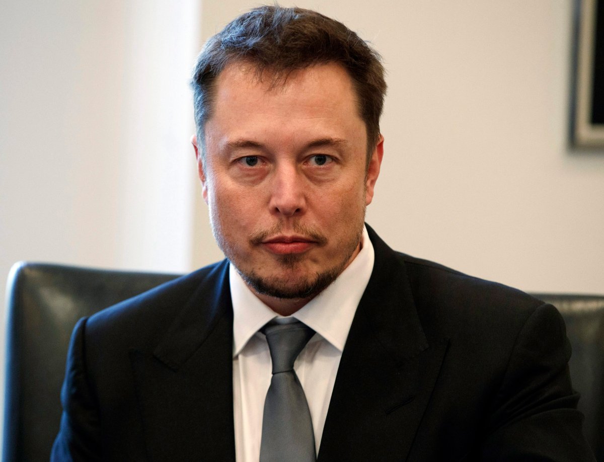 In this Dec. 14, 2016, file photo, Tesla CEO Elon Musk listens as President-elect Donald Trump speaks during a meeting with technology industry leaders at Trump Tower in New York. 