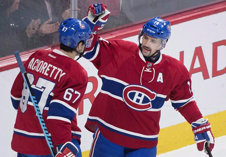 In this file photo, Montreal Canadiens' captain Max Pacioretty (67) celebrates with teammate Tomas Plekanec. Plekanecwho was dealt to the Leafs in February is back with the Habs after signing a one-year contract for US$2.25 million. Sunday, July 1, 2018.