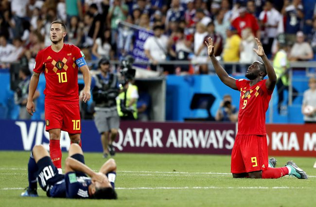 Belgium stars Romelu Lukaku (9) and Eden Hazard (10) react after their team’s dramatic 3-2 win over Japan, as Shinji Kagawa of Japan lies on the turf in despair