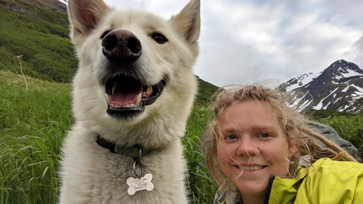This Tuesday, June 19, 2018 photo by Amelia Milling shows her with a 7-year-old Alaskan husky named Nanook, that is credited with helping rescue her when she injured was hiking a trail in the Chugash State Park east of east of Anchorage, Alaska. 