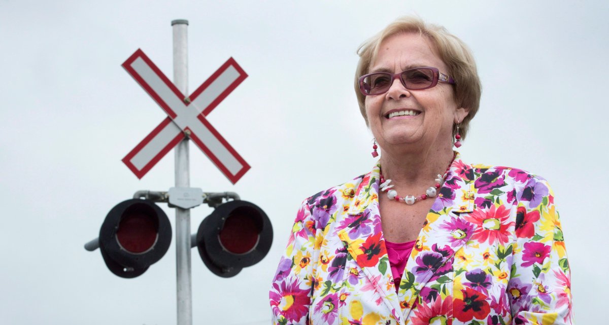 Former Mayor Colette Roy-Laroche stands next to a railroad crossing along a street of the new downtown core in Lac-Megantic, Que., on June 10, 2014. 