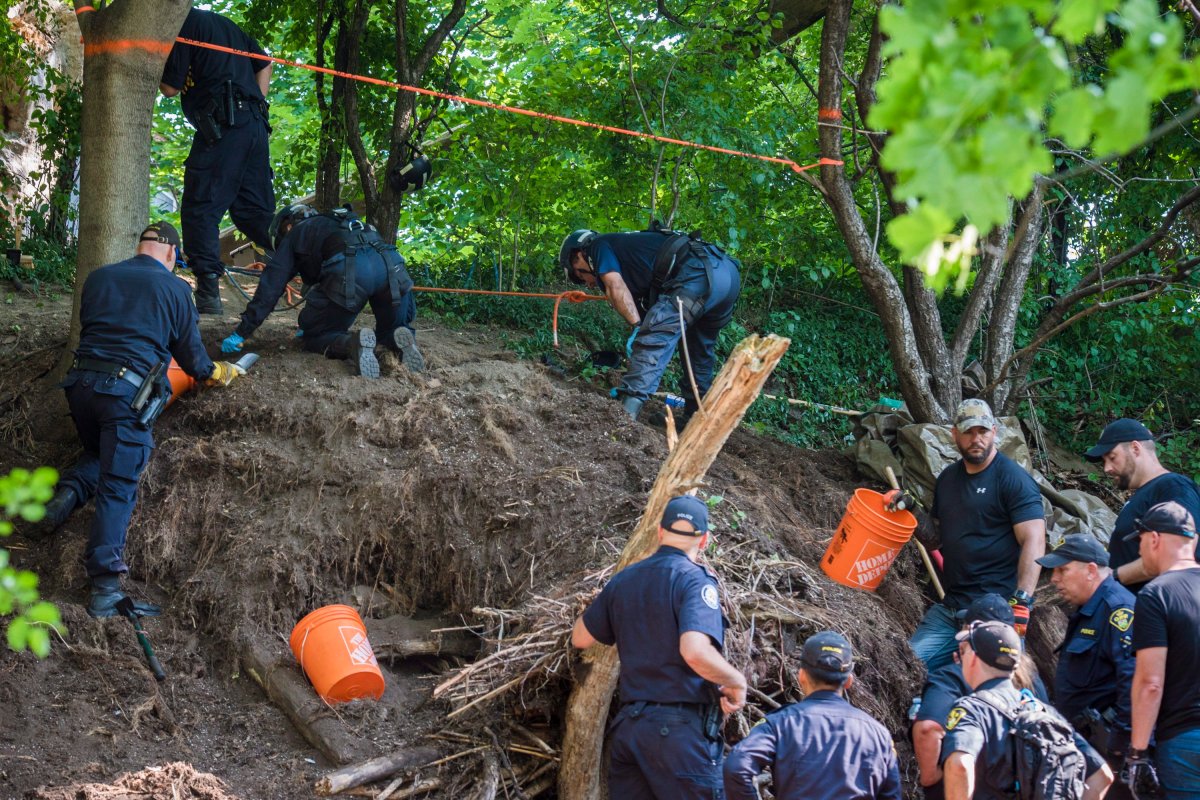 Members of the Toronto Police Service excavate the back of property along Mallory Cres. in Toronto after they found human remains during an investigation in relation to alleged serial killer Bruce McArthur on Thursday, July 5, 2018.