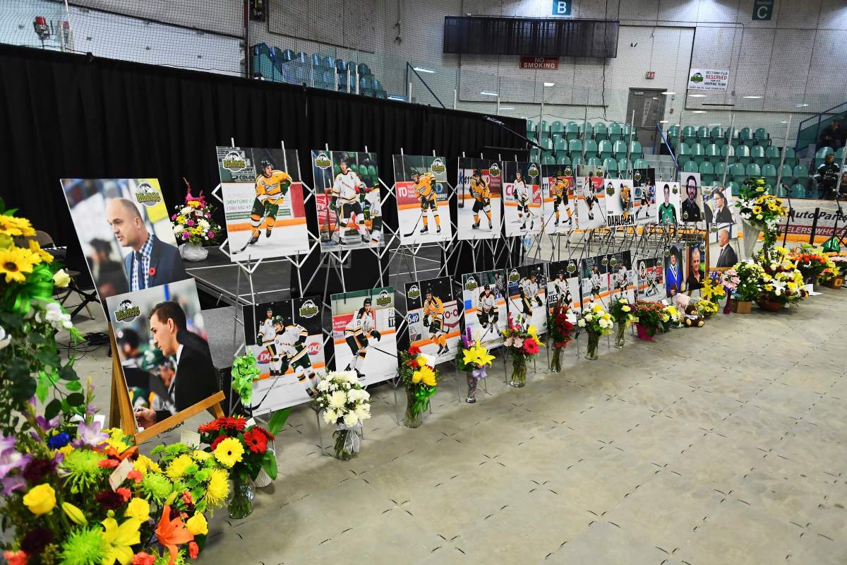 In this April 8, 2018, file photo, photos of people involved in a fatal bus crash are displayed prior to a vigil at the Elgar Petersen Arena, home of the Humboldt Broncos, in Humboldt, Saskatchewan.
