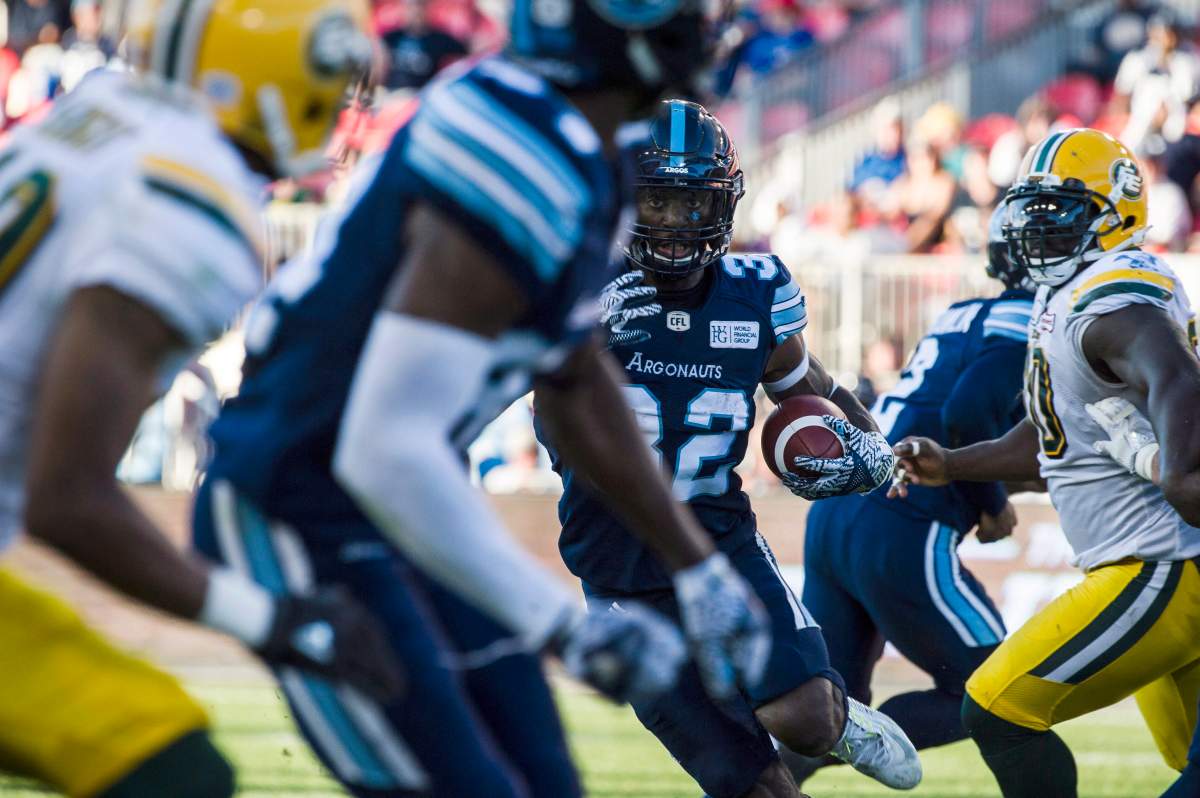 Toronto Argonauts running back James Wilder Jr. (32) evades the defensive line of the Edmonton Eskimos fourth quarter CFL action in Toronto on Saturday, July 7, 2018. 